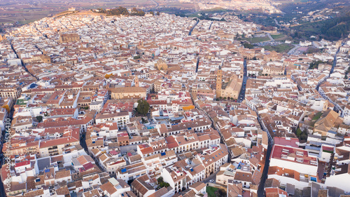 Typical Andalusian town seen from above aerial drone view in Antequera. South Spain city with churches and historical buildings in Andalusia bird view