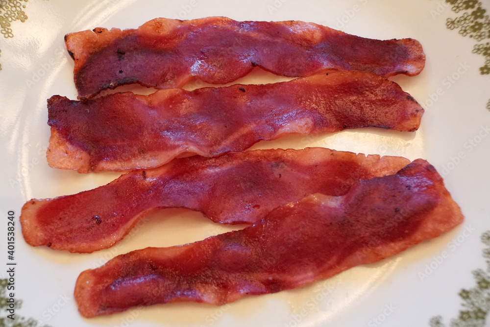 Close up of crispy turkey bacon on the white plate Close up of crispy turkey bacon on the white plate