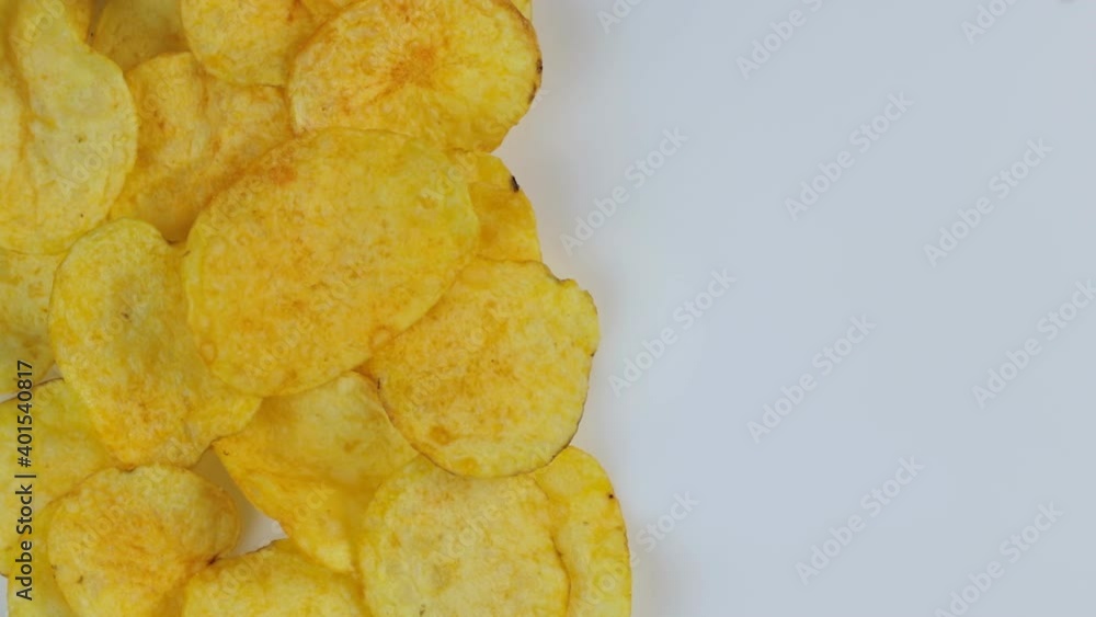 Classic potato chips rotate on a white background. Space for text. Classic potato chips rotate on a white background. Space for text.