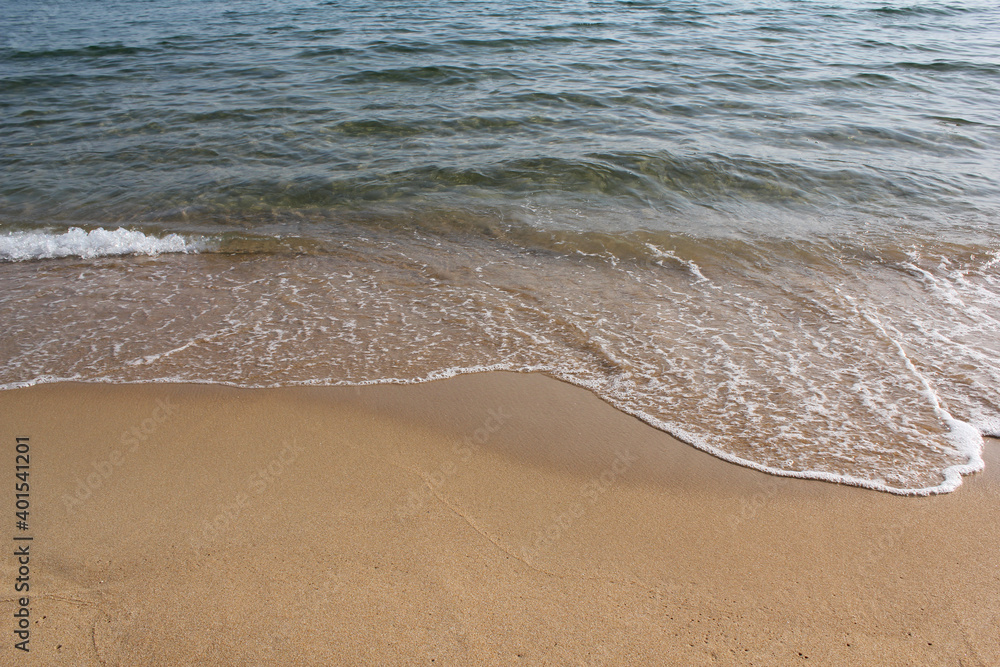 Soft beautiful ocean wave on sandy beach. Background