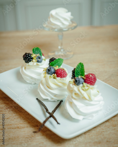 Homemade meringue dessert Pavlova cake with fresh strawberries and mint. Summer dessert. French cake. Confectionery. Classic dessert. Strawberry dessert photo