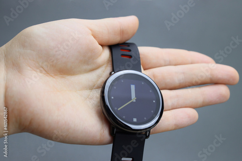 Hand holding Touch smartwatch with round display