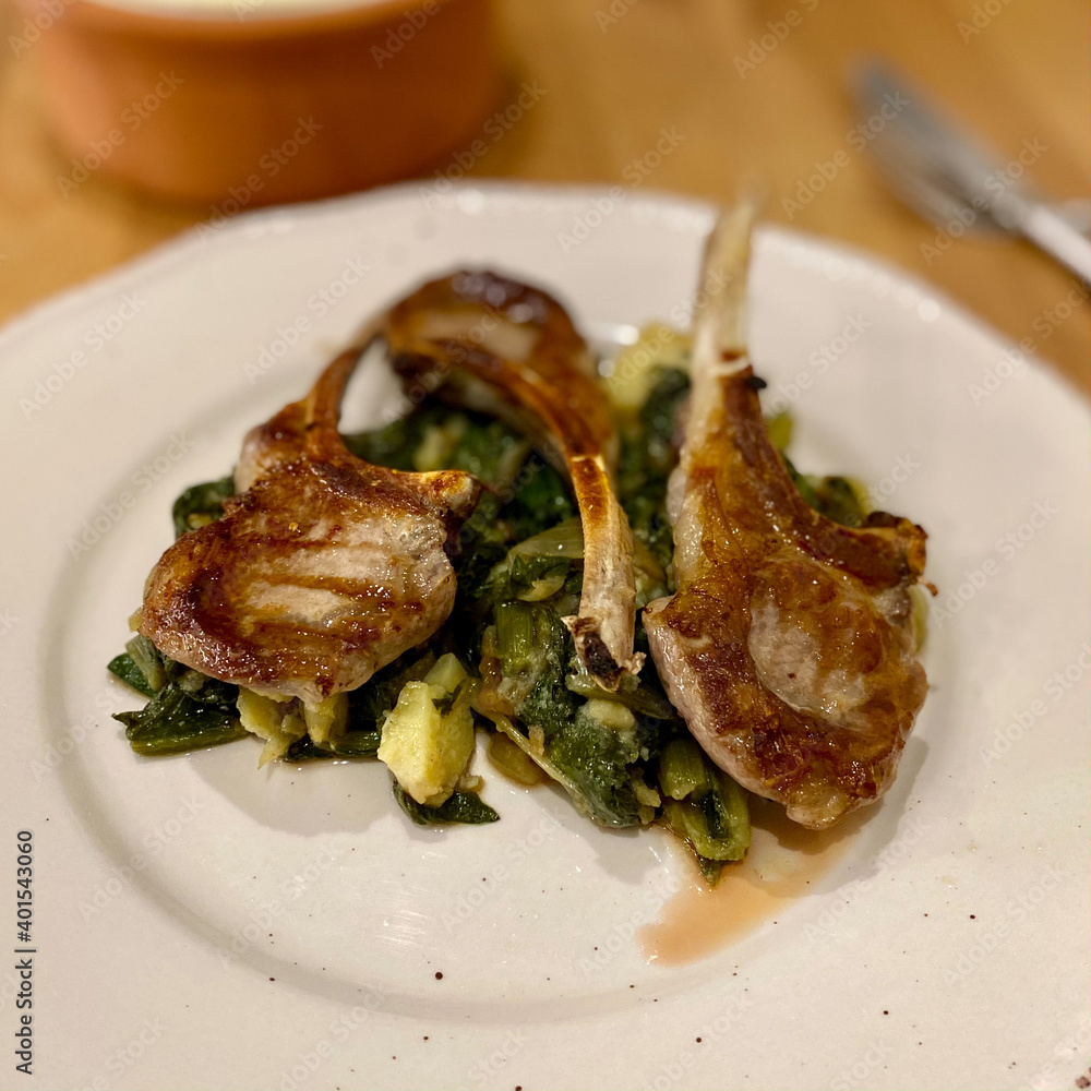 Homemade Lamb Chops with Chard Food Vegetables and Potatoes served in Plate.