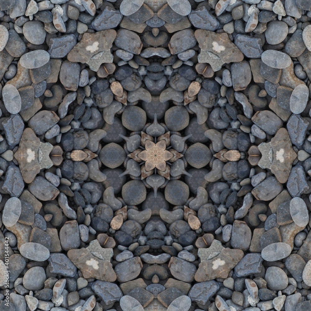 kaleidoscopic style of pebbles on a beach with colourful child's play fork and rake kaleidoscopic style of pebbles on a beach with colourful child's play fork and rake