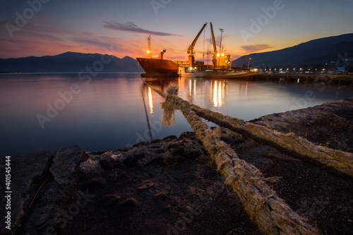 The ship anchored in port at dusk