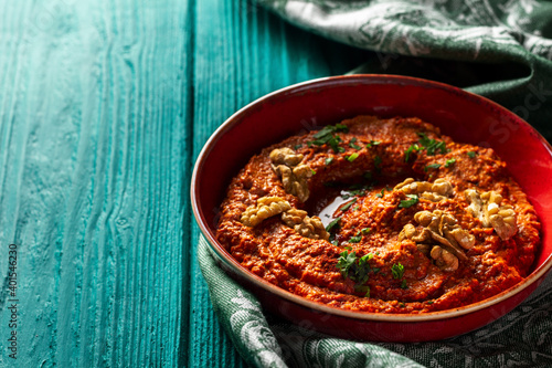 Roasted red bell pepper spread in a red bowl  with a vintage napkin photo