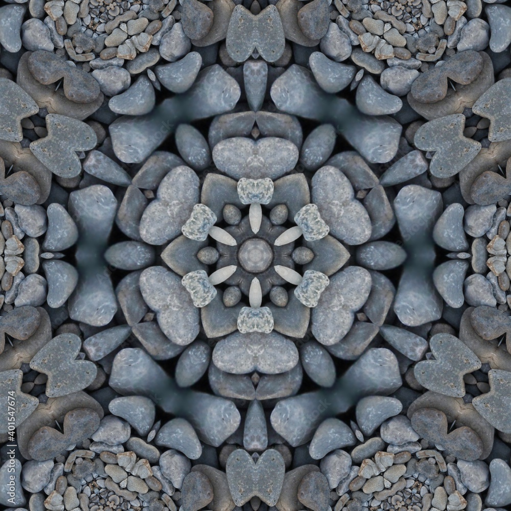 kaleidoscopic style of pebbles on a beach with colourful child's play fork and rake kaleidoscopic style of pebbles on a beach with colourful child's play fork and rake
