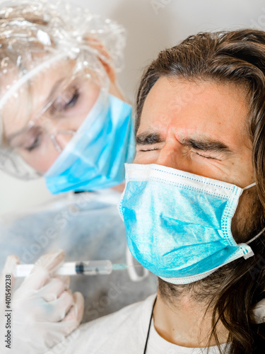 Nurse vaccinating a young patiente photo