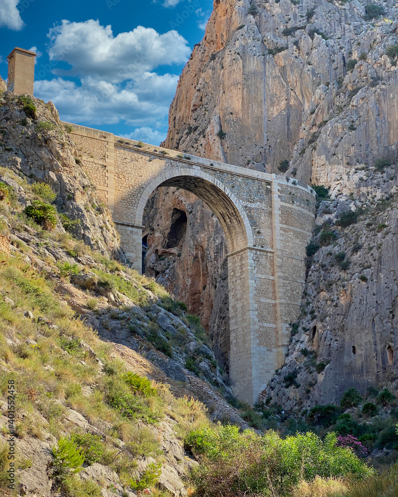 ancient roman bridge joining a canyon