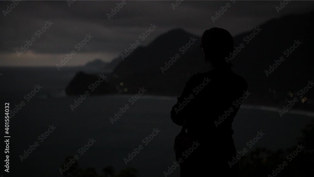 Girl silhouette overlooking coastline almost at night in Taiwan. Mid angle, parallax movement, slow motion, HD. Girl silhouette overlooking coastline almost at night in Taiwan. Mid angle, parallax movement, slow motion, HD.