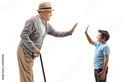 Elderl man and a boy gesturing high-five