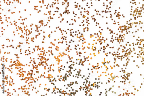 christmas or new year background of gold foil confetti scattered on a white table