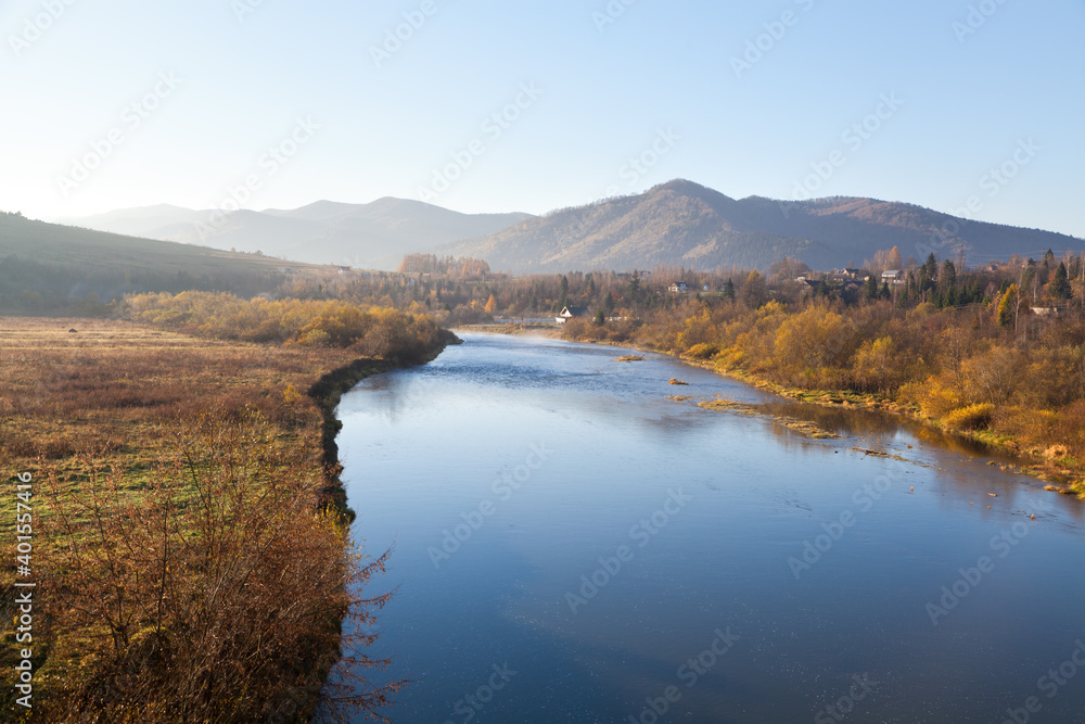 Autumn morning on Stryi river, mountains on the horison. Ukraine, Carpathians.