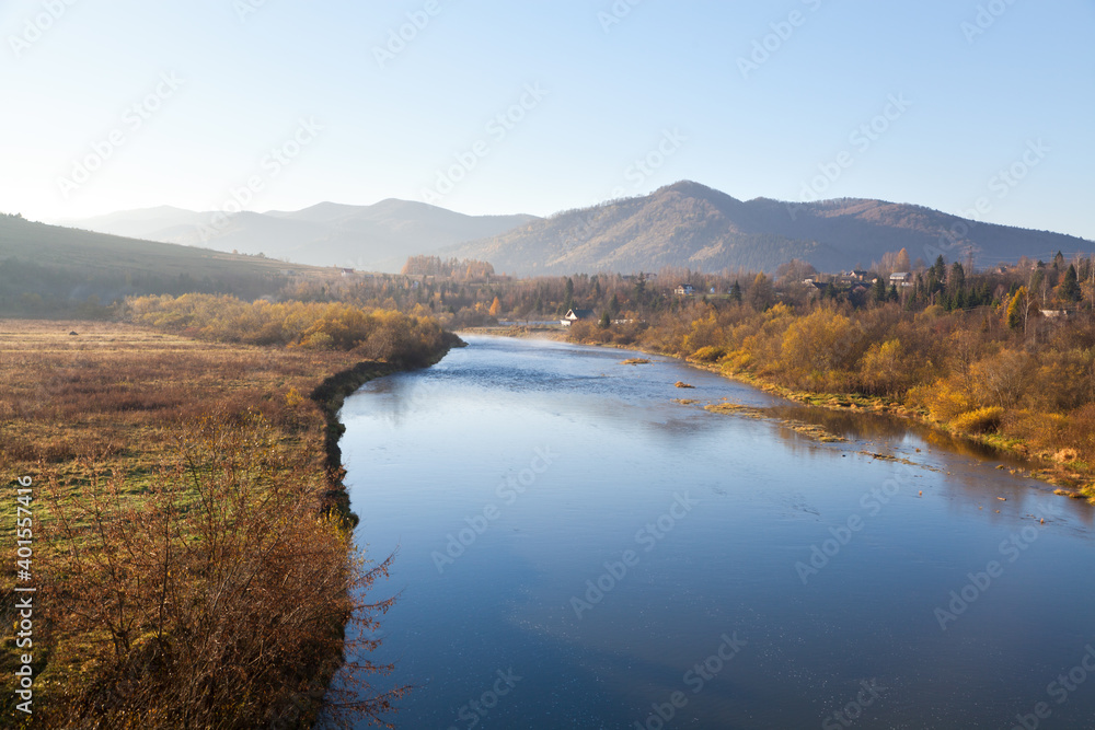 Fototapeta premium Autumn morning on Stryi river, mountains on the horison. Ukraine, Carpathians.