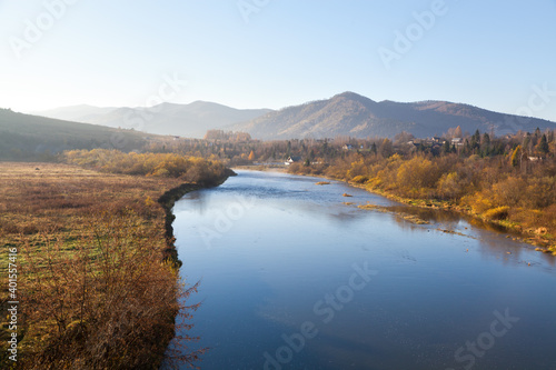 Autumn morning on Stryi river, mountains on the horison. Ukraine, Carpathians.