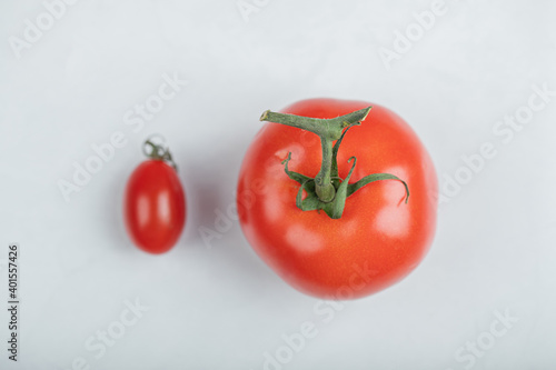 Big red tomato e and cherry tomato on white background