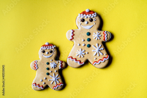 Christmas gingerbread in the shape of angel on yellow background.