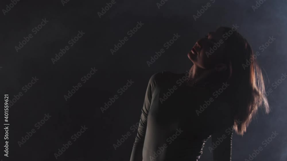Vogue - young attractive woman dances in the dark room Vogue - young attractive woman dances in the dark room