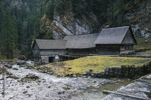 Old cottages or old wooden water mill at National Nature Reserve Kvacianska dolina in Slovakia winter.  Slovak nature. It has been restored and serves as a museum. photo