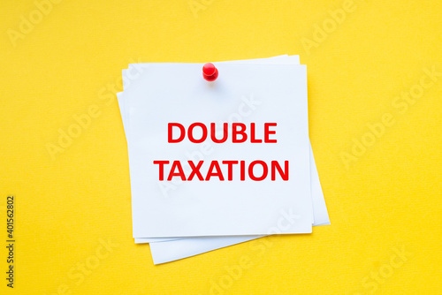 Text double taxation on white sticker with yellow background