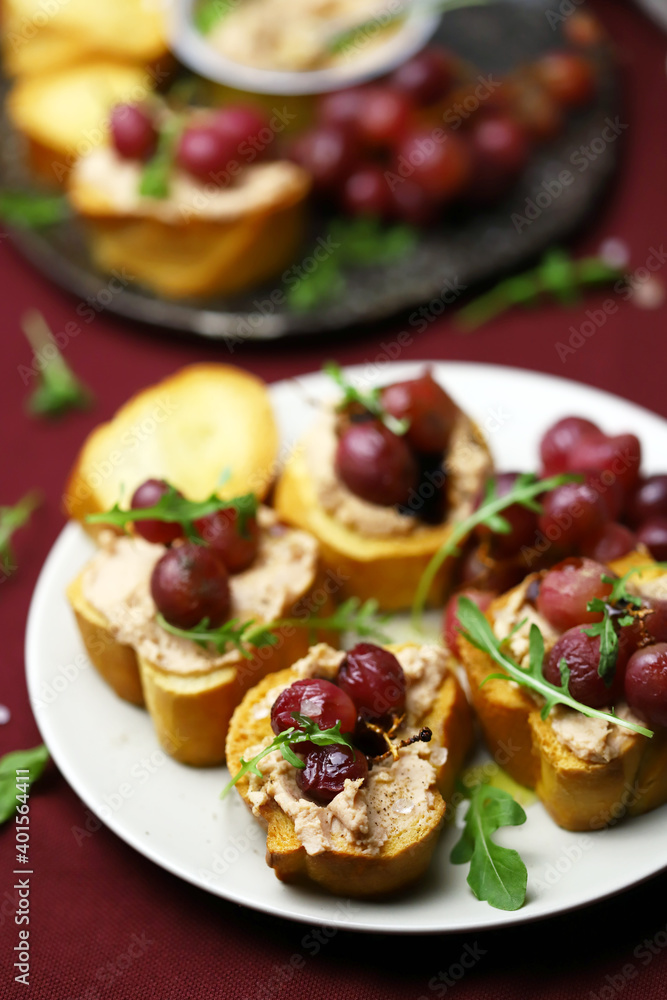 Selective focus. Toast with pate and grapes. French cuisine.