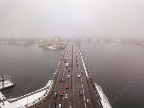 Aerial drone view. Automobile bridge over the Dnieper river in Kiev in the morning fog. © Sergey