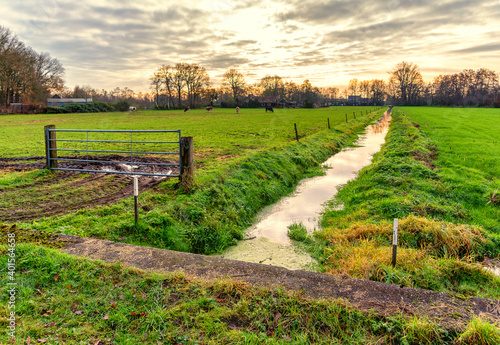Tableau sur toile December sunset over a polder landscape with a ditch in Lunteren NL