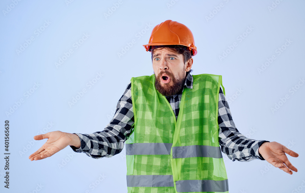 Emotional Builder is gesturing with his hands an orange helmet reflective vest