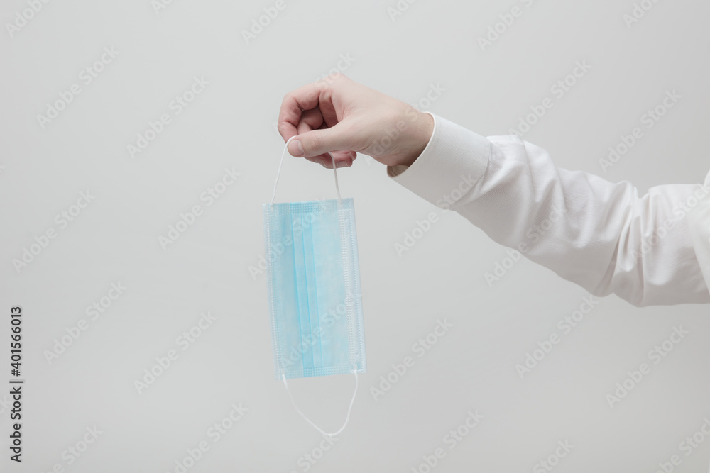 Male hand hold one medical protection mask Male hand hold one medical protection mask