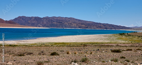 Orto Tokoy Reservoir in Kyrgyzstan with blue sky and azul water photo