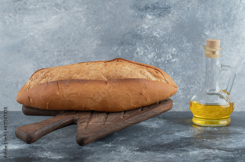 Photo of White bread with oil on the wooden board photo