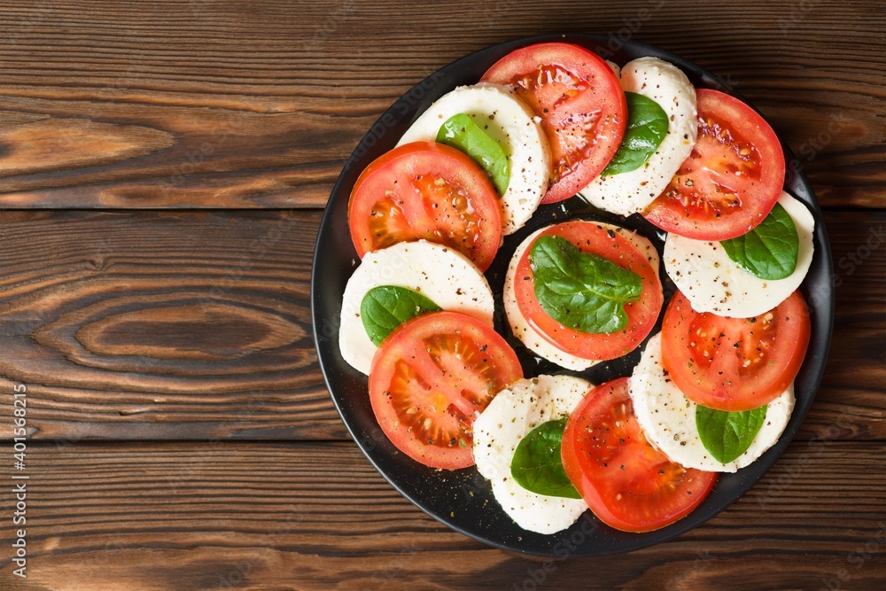 Italian caprese salad on a round plate Italian caprese salad on a round plate