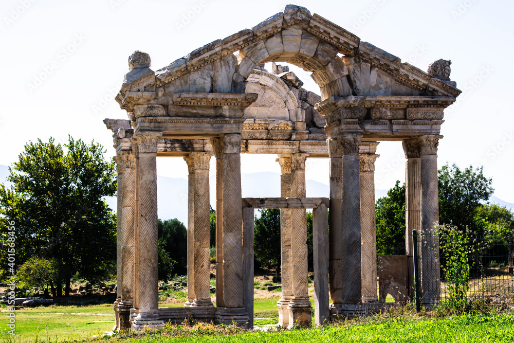 Afrodisias, Geyre, Aydın, Turkey - August 2020: Tetrapylon, Aphrodisias Ancient City. The Aphrodisias is an Aphrodite temple and it's in ruins of Aphrodisias Ancient City.