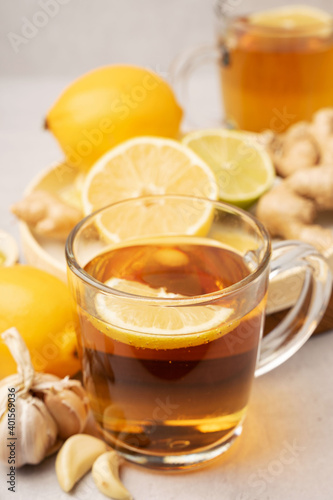 Hot herbal tea with ginger, garlic, lemon and honey vitamins C over grey background. Concept alternative medicine, natural homemade remedy for cold and flu. Support the immune system. Well-Being and