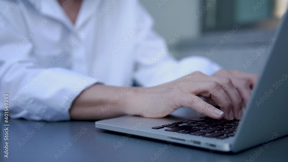 Close-up female hands typing on laptop keyboard, woman chatting or working on pc Close-up female hands typing on laptop keyboard, woman chatting or working on pc