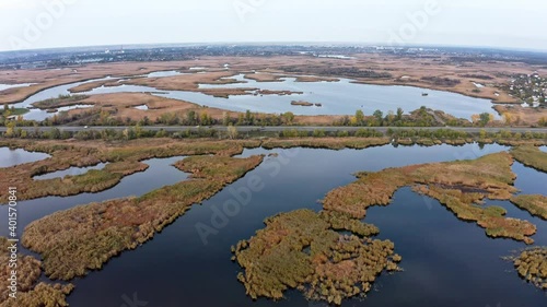 Aerial view of the Samarskie Plavni on the Dnieper in Ukraine in the evening warm bright light. Aerial UHD 4K drone realtime video, shot in 10bit HLG and colorized