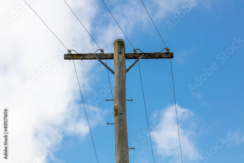 A wooden telephone pole with wires and terminal connectors