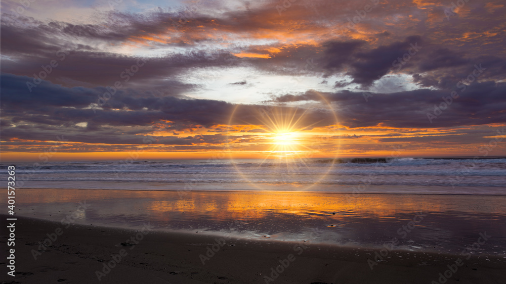Golden sunrise across the ocean on a beach Golden sunrise across the ocean on a beach