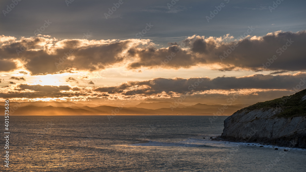 Golden sunset across an aquamarine ocean