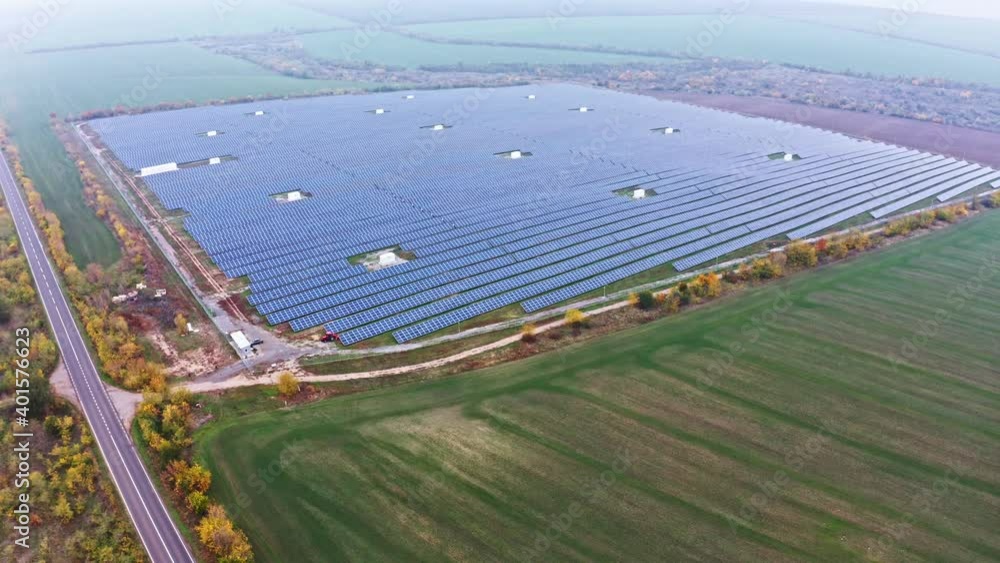 Huge solar power plant to use solar energy in a picturesque green field in Ukraine. Aerial UHD 4K drone realtime video, shot in 10bit HLG and colorized Huge solar power plant to use solar energy in a picturesque green field in Ukraine. Aerial UHD 4K drone realtime video, shot in 10bit HLG and colorized