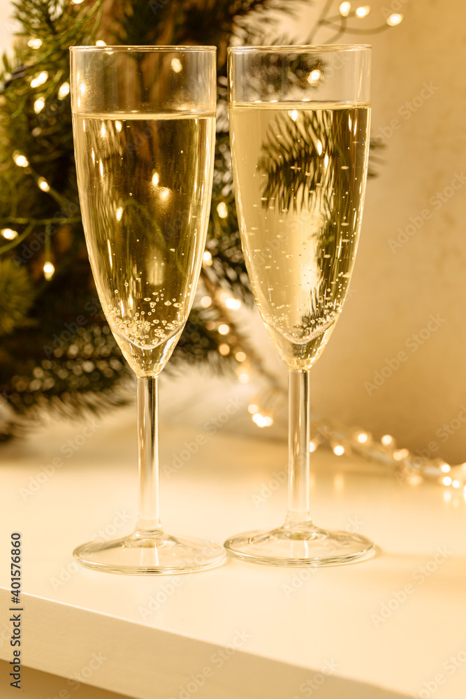 two glasses of champagne with white background and lights two glasses of champagne with white background and lights