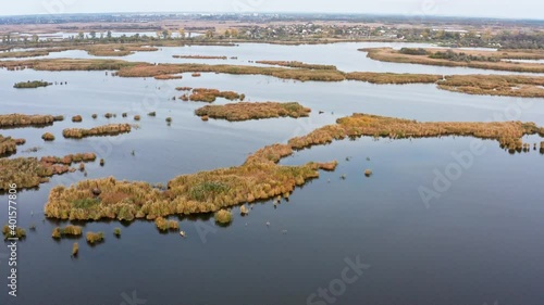 Irresistible floods on the Samara River on the Dnieper in Ukraine in the evening warm bright light. Aerial UHD 4K drone realtime video, shot in 10bit HLG and colorized