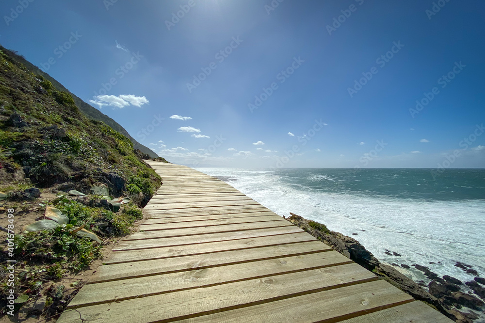 Low angle view of wooden footpath along hiking trail at Robberg Nature Reserve, Plettenberg Bay, South Africa.