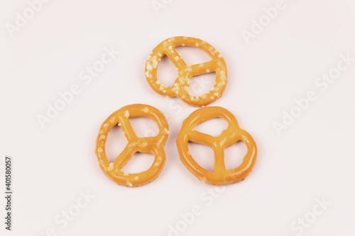 Three dry salty crackers lie on a white background