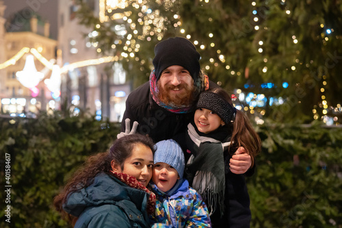 Photography Happy multinational family outdoor in a city center at Christmas