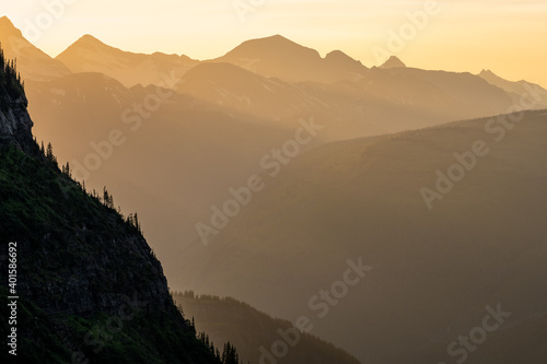 Sunlight Filters Through Sky Over Mountain layers © kellyvandellen