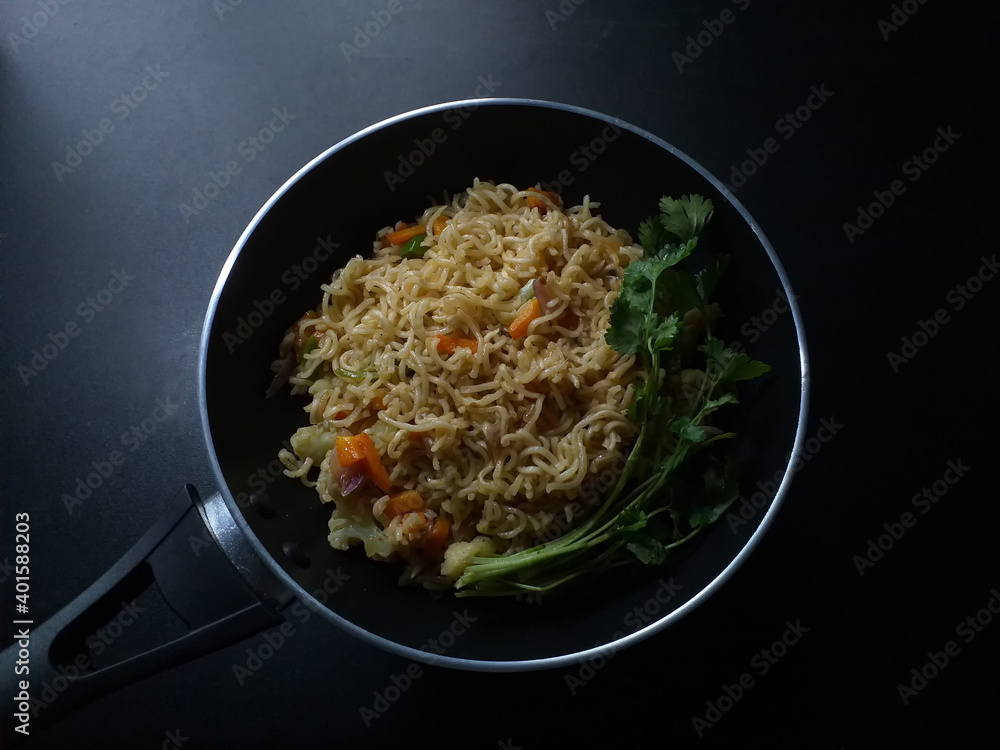 Traditional black pan of instant noodles dark background Traditional black pan of instant noodles dark background
