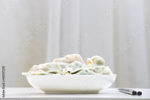 A plate of steaming three fresh dumplings