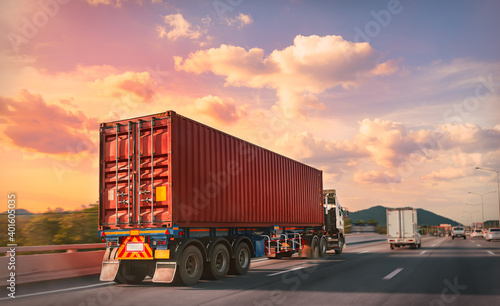 Obraz na plátně Truck with red container on the highway with sunset time, logistic import export