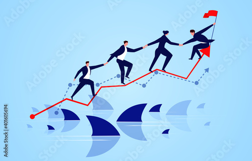 Team members help each other to overcome the risk and cross the shark zone